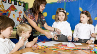 School support worker with children in classroom